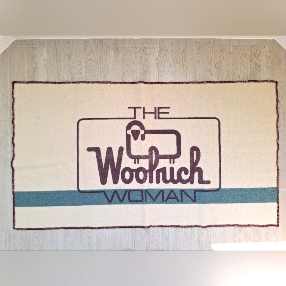 The Woolrich Woman cream, brown and blue Woolrich sheep logo heavy wool blanket